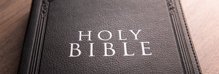 Holy Bible on the wooden table backgroundの写真素材