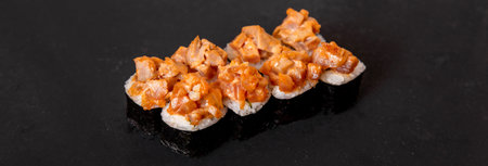 close up of a sushi roll over a black backgroundの写真素材
