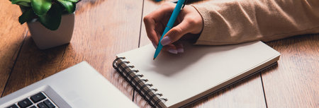 female hands with notebook and pen. Business woman working at the table in the office