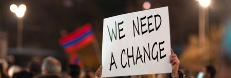 man with we need a change. Young people protesting on the streetの写真素材