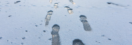 Footprints on the snow in winterの写真素材