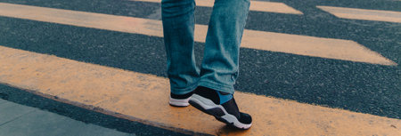 young fashionable man crossing the streetの写真素材