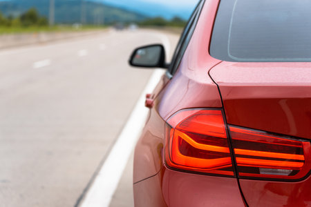 Red car on the road, rear viewの写真素材