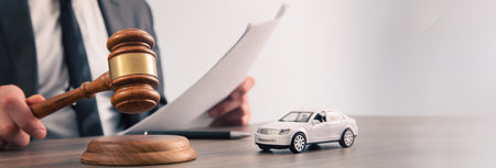Model of car and gavel. Accident lawsuit or insuranceの写真素材