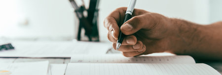 Man writes in a notebook on the desktopの写真素材