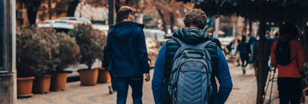 A man walks around the city with a backpack. Hiking conceptの写真素材