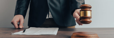 A man holds a judge's gavel. The court's decisionの写真素材