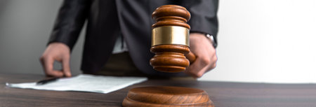The judge hits the gavel in front of the papersの写真素材