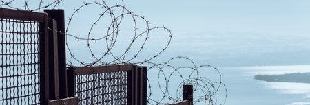 Fence with metal wire during the dayの写真素材