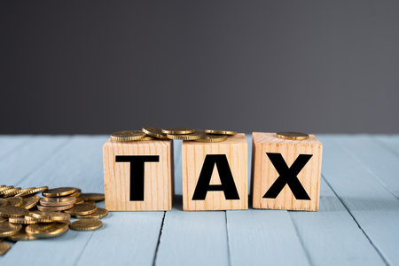 TAX inscription and coins on the tableの写真素材