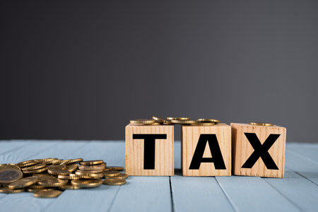 TAX inscription and coins on the tableの写真素材