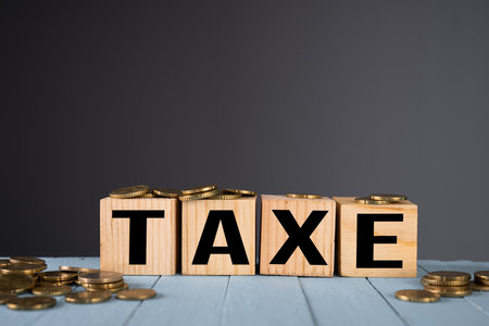 TAXE inscription and coins on the tableの写真素材