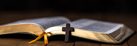 cross on book on wooden tableの写真素材