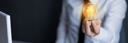 man hand light bulb in desk
