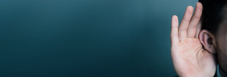 young man hand in earの写真素材