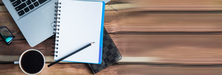 notepad on keyboard with coffee on deskの写真素材