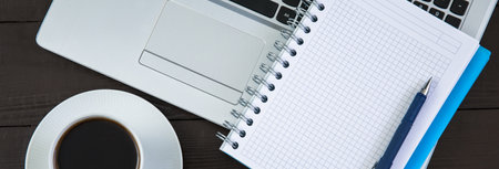notepad with cup of coffee and computer keyboard