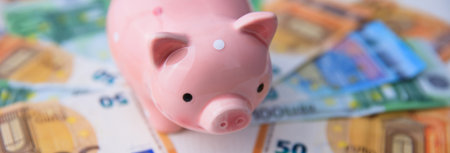 piggy bank with money on deskの写真素材