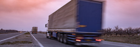 truck on road at sunsetの写真素材