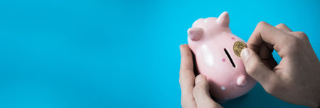 man hand coin with piggy bank on deskの写真素材