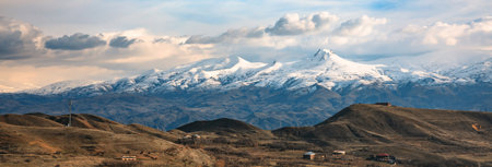mountain in winter under skyの写真素材