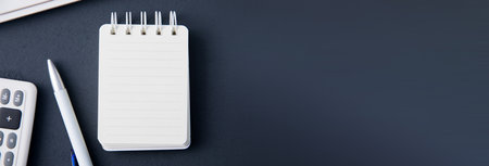 notepad with calculator and keyboard on desktopの写真素材