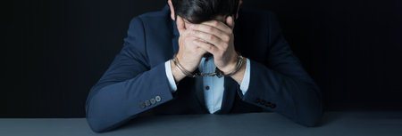 man hand handcuffs in face