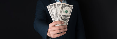 young business man hand holding moneyの写真素材