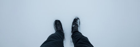 man feet and shoes on snowの写真素材