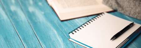 woman hand book with notepad on desk