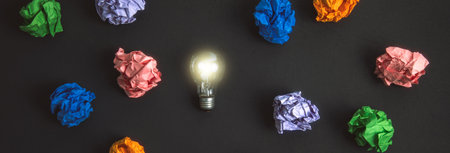 bulb with colorful papers on the desk