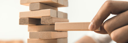 man hand wooden cubes on deskの写真素材