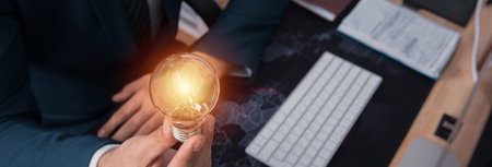 man hand light bulb in office desk