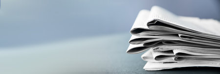 Pile of newspapers on gray background