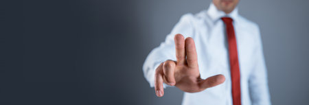 man touching in screen on gray wall backgroundの写真素材