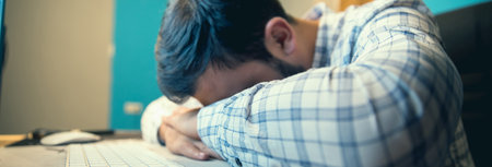 sad tired man in office deskの写真素材