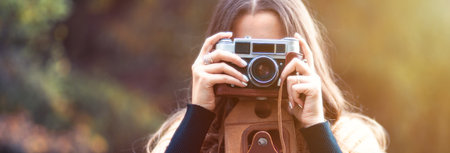 woman hand photo camera in gardenの写真素材