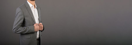 business man hand in suit on gray backgroundの写真素材