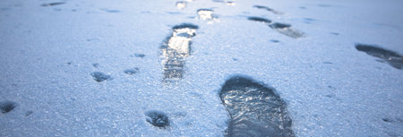 human footprints on snow in dark day