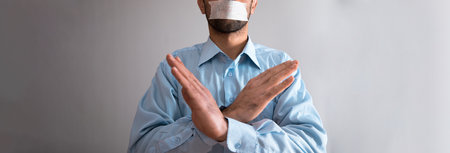 man close mouth and stop sign on gray background