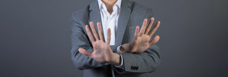 businessman hand stop sign on gray background