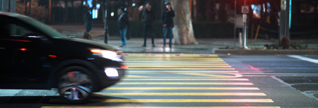 car in crosswalk in night street backgroundの写真素材