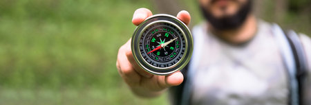 traveler man hand holding compass in nature