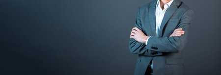 young businessman cross hands on dark backgroundの写真素材