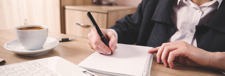 woman hand notepad with computer on the tableの写真素材