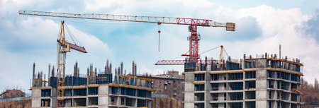 Crane and building construction site against blue sky