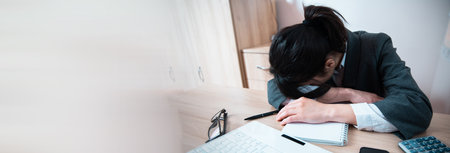 sad or tired woman in working table backgroundの写真素材