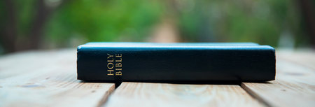 Holy Bible on the table in nature background