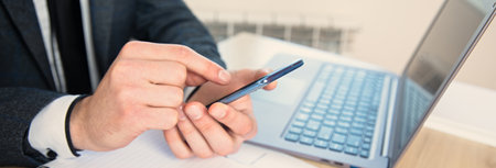 man hand phone in working desk background