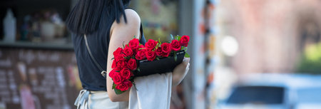woman hand beautiful roses in the streetの写真素材